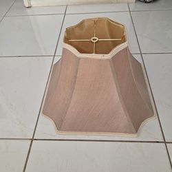 Vintage beige fabric lamp shade, bottom 17" square, height 7". Gold satin interior, decorative cord trim. Good pre‑owned condition. Fits standard lamp