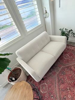 Cream colored mid century modern couch