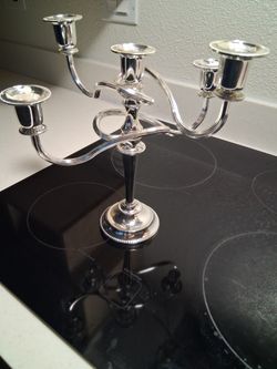 Vintage, silver-plated candelabra, often featuring swing arms or a convertible design allowing it to be used as a multi-light holder or a single candl