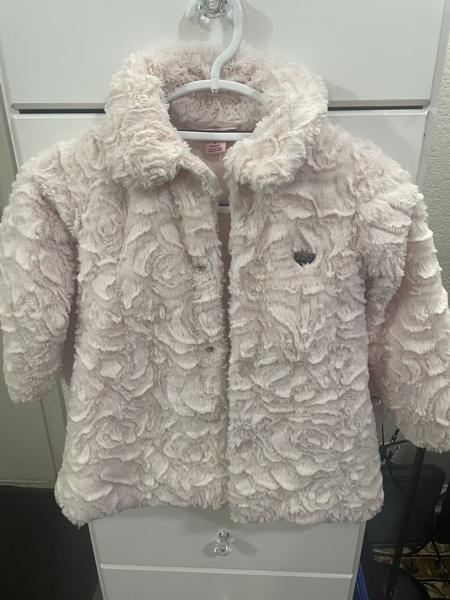 Pink girls' faux fur coat with a rose pattern.