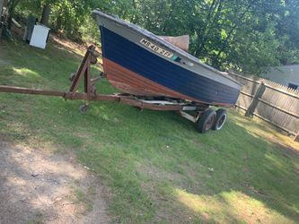 Wooden boat, motor, and trailer