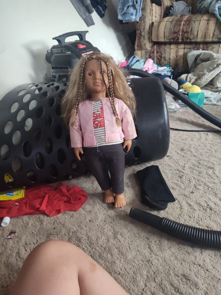 Doll With Two Braids A Pink Jacket And Leggings And A Shirt