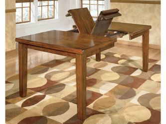 Ralene Medium Brown Dining Table w/ Butterfly Extension