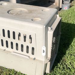 Dog Kennels Plastic One Is A Little Dirty From Being Outside & The Another Kennel Is Open From One Corner Where I Would Feed My Dog Doggy Treats. 