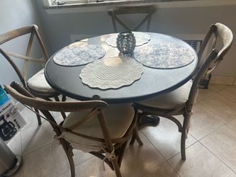 Restoration Hardware and table is Aero Wood Round Dining Table and Madeleine Side Chairs