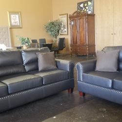 Dark brown faux leather sofa and loveseat
