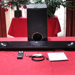 LG Soundbar sound system with Bluetooth, wireless active subwoofer, and remote control.
