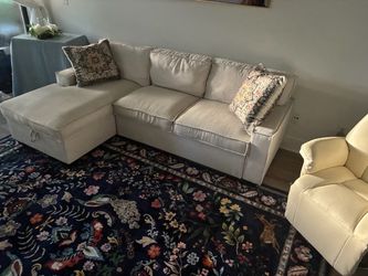 Sectional with pullout sleeper and white leather, easy chair.