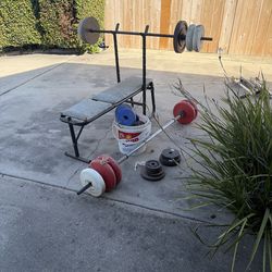 Bench press, deadlift bar, and weights