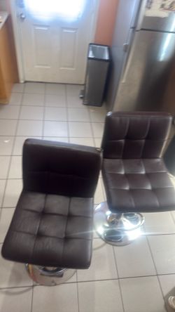 Two brown bar stools