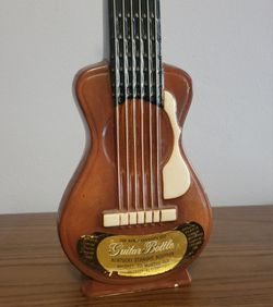 Antique liquor guitar bottle