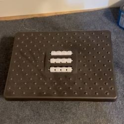 Adjustable footrest with massage rollers