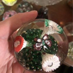Vintage clear glass paperweight with long flowers inside