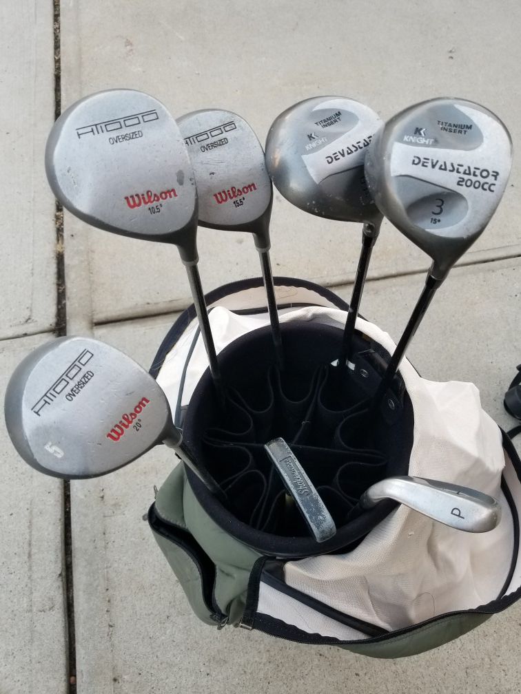 Golf clubs, bag, and push cart