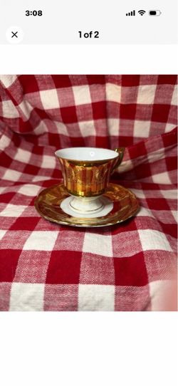 Gold and White Porcelain Tea Cup and Saucer