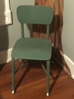 Child’s green metal chair