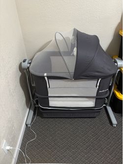 Gently used electronic rocking bedside bassinet cradle