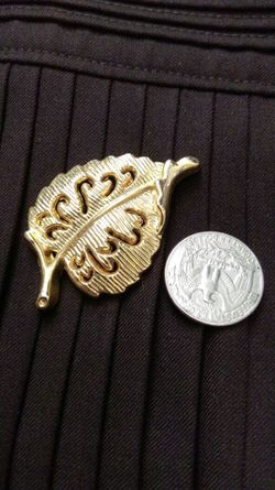 Gold leaf pin marked AAL