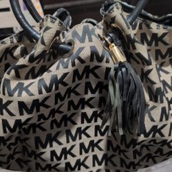 Michael Kors Medium East West Ring Tote bag in a black and brown signature canvas with leather trim
