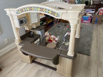 Play kitchen with dishes, food, stool, and play phone