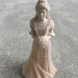 cream, colored glass cologne bottle of a bride