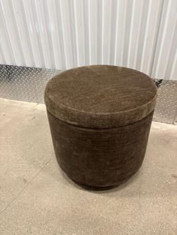 Gray cloth foot stool … in good condition. Swivels and With storage space inside .  18 “ round x 17 “ high … $40