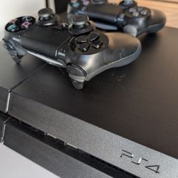 PS4 with controllers, cables and manuals