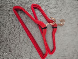 Red velvet hangers with gold hooks