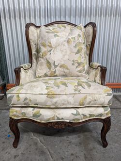 Vintage Wingback Armchair with Floral Upholstery and Carved Wood Frame