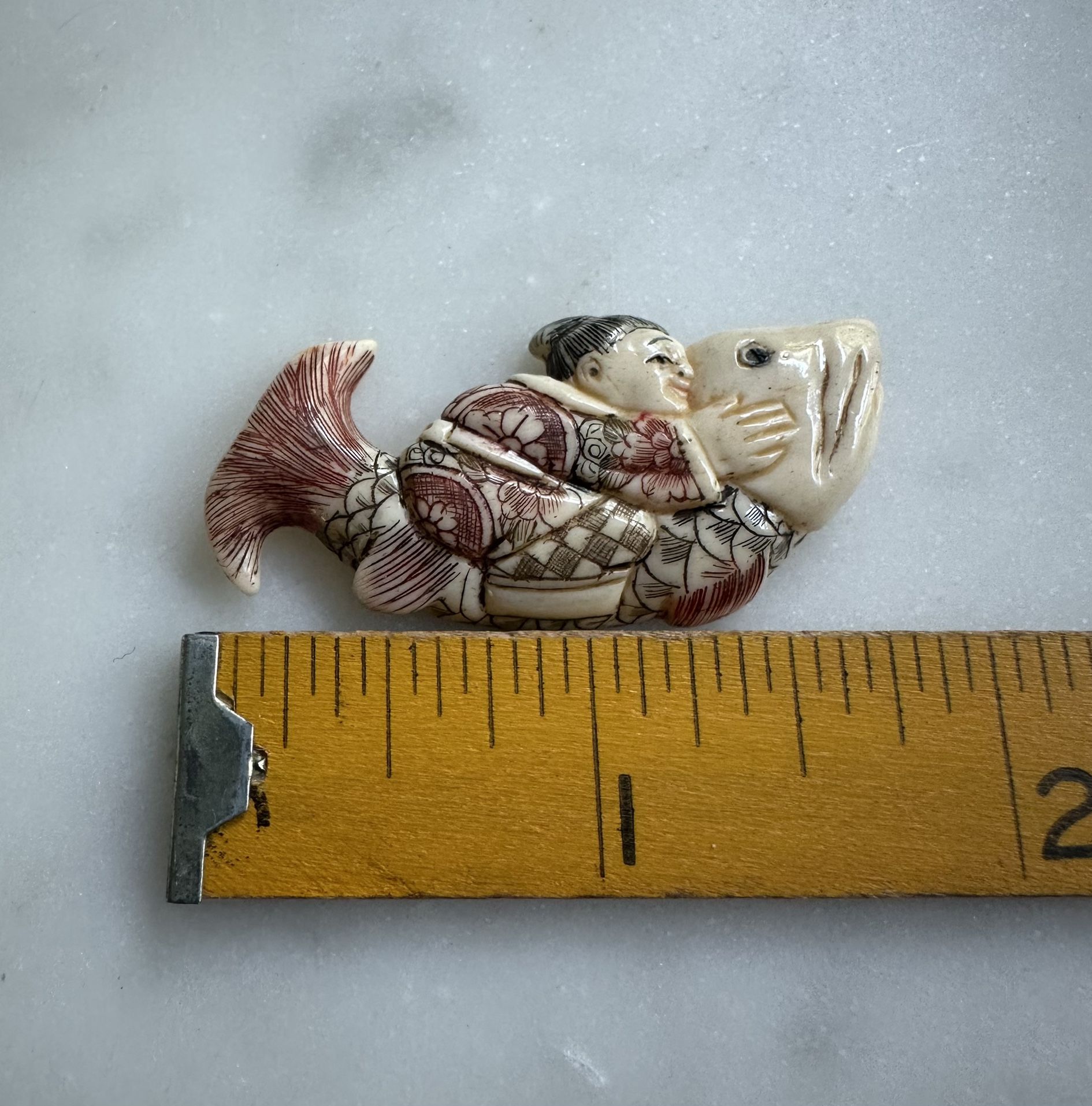 Japanese Boy And Fish Bone Carving
