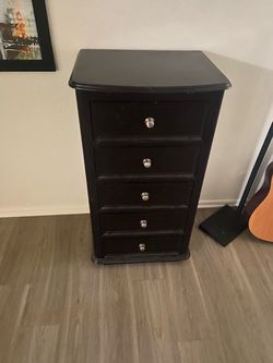A tall skinny dresser