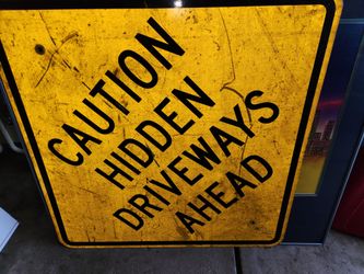 caution hidden driveways ahead road sign