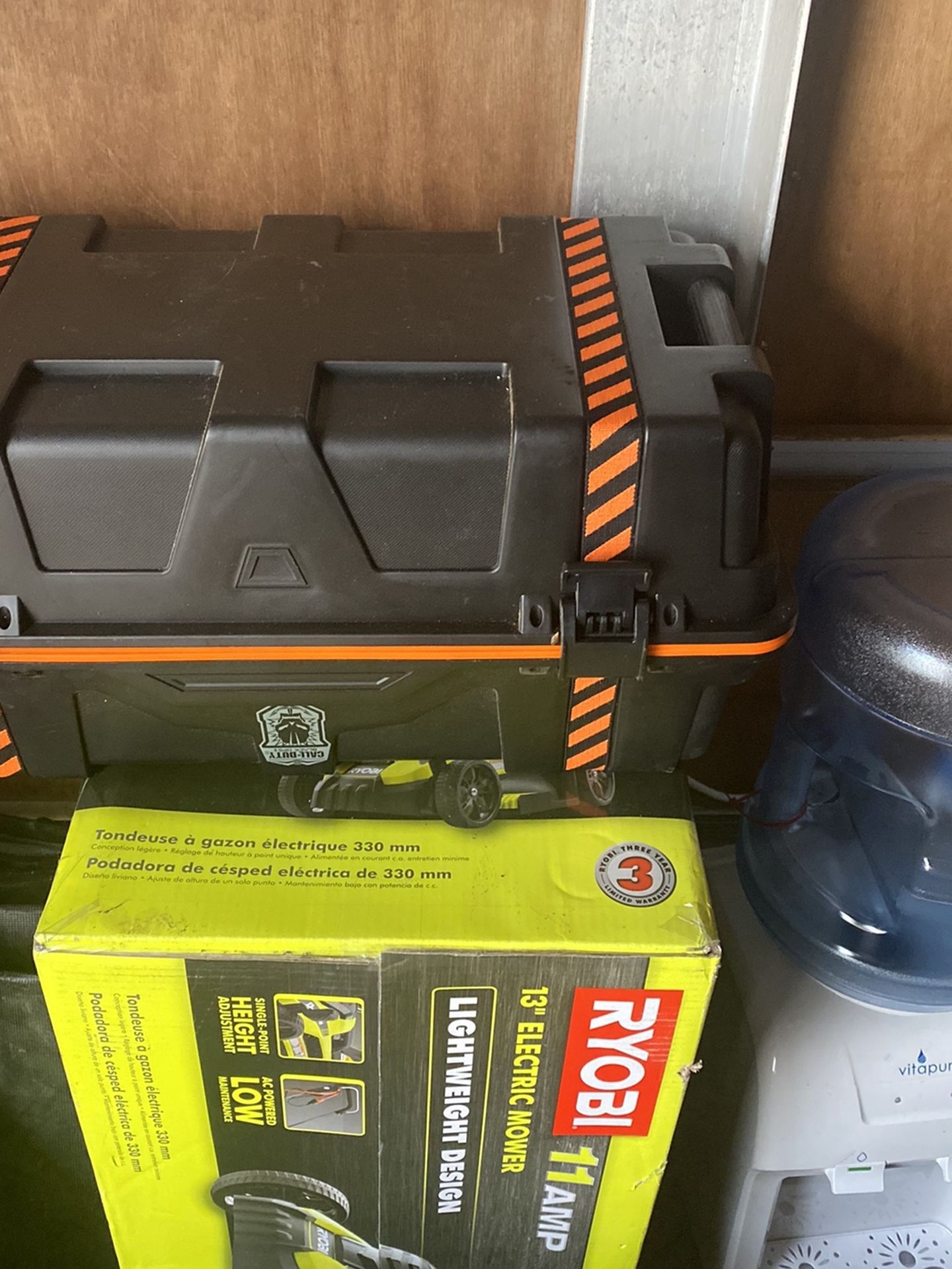 Brand new lawnmower and a sealed to Keith and a water dispenser with jug make a
