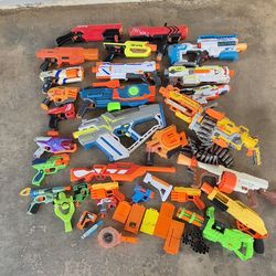 Nerf guns  qty 27 and some accessories