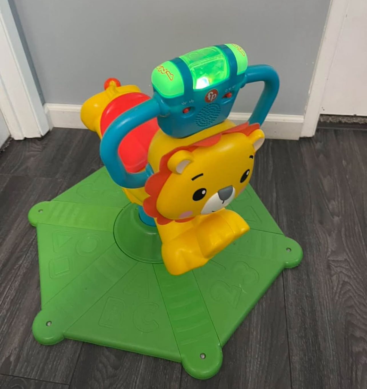 Fisher-Price Bounce & Spin Lion Stationary Ride-On toy with music
