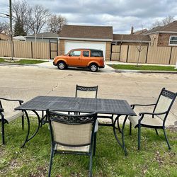 Large patio table 6x3 and 4 chairs, 1 of the chairs has some foam spray on it, but is still usable