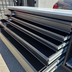 <HUSKY.
HEAVY DUTY
96 in. W x 24 in. D 9-Drawer Heavy- Duty Mobile Workbench with Stainless Steel Top in Matte Black