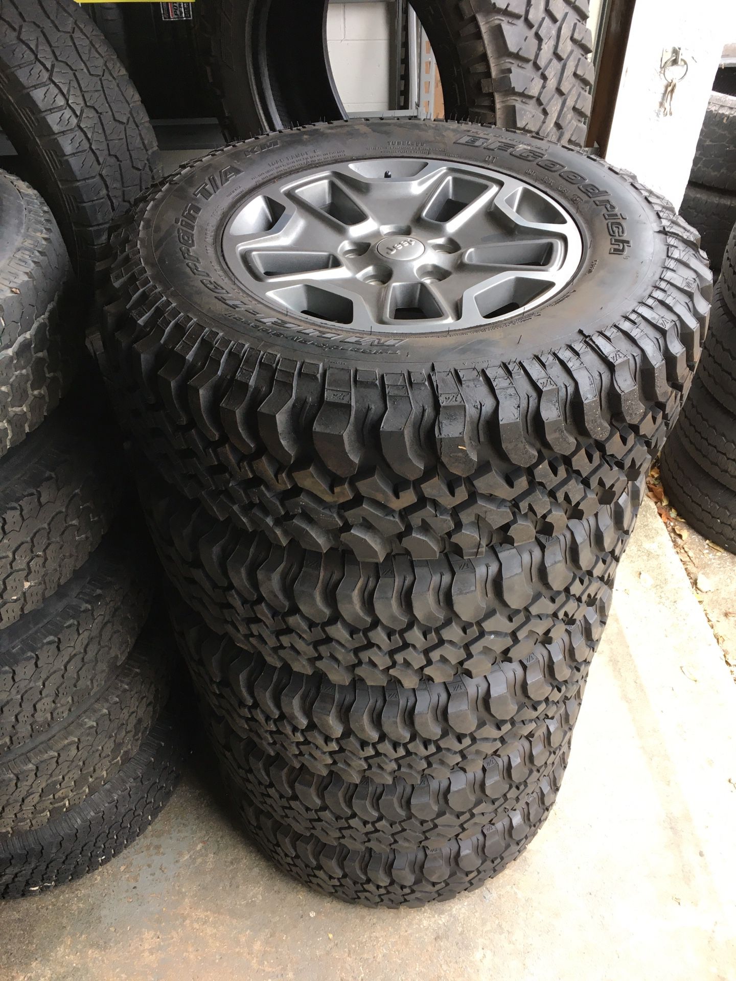 5) 255/75/17 BFGoodrich Mud Terrain KM Tires, with Jeep Rubicon wheels.