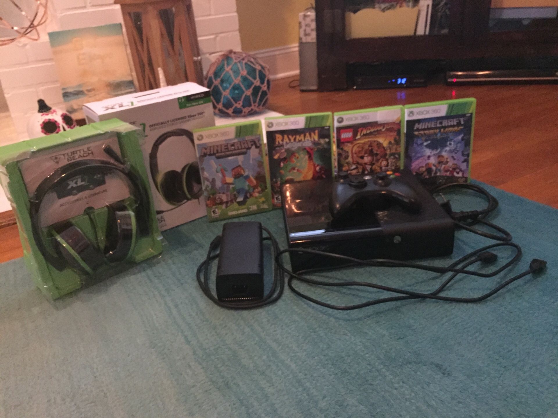 Good condition Xbox 360, Xbox 360 controller, 4 Xbox 360 games, and Turtle Beach Ear Forces XL1 wired headsets.