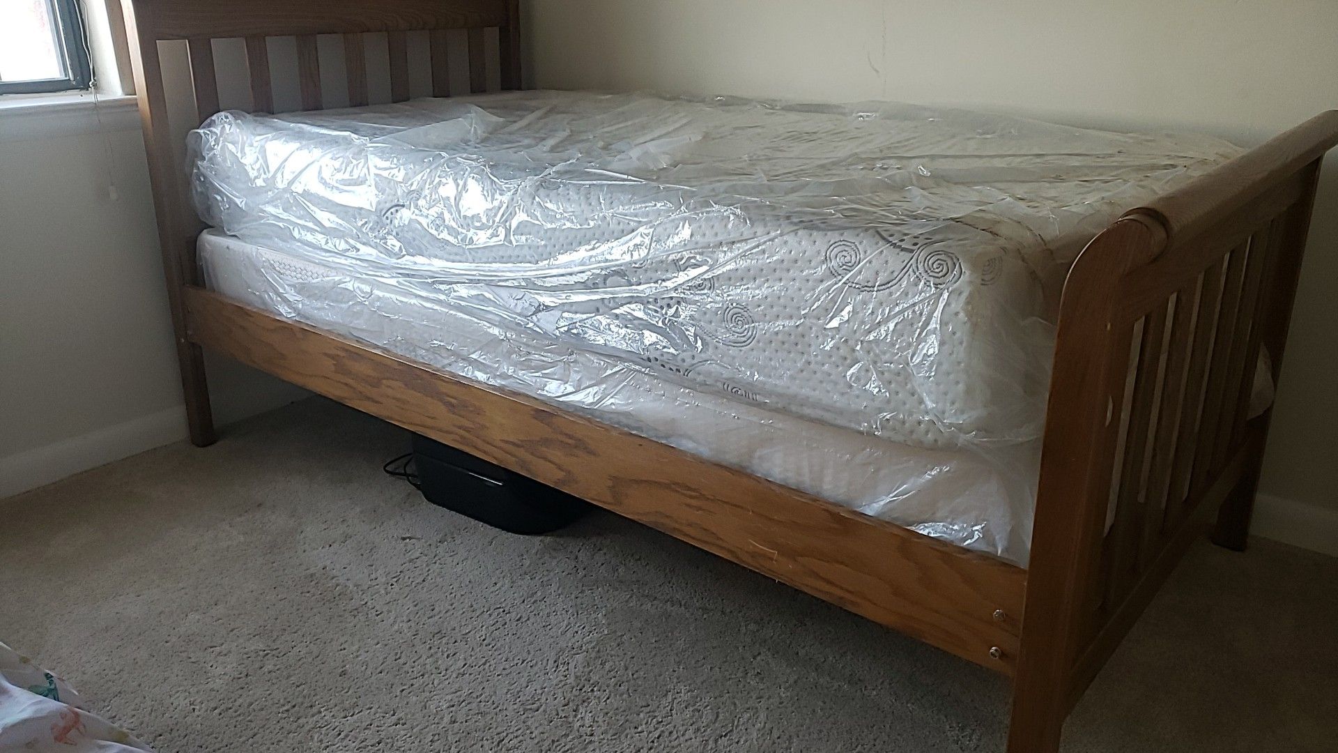 Twin Bed with Mattress covered in Plastic wrap