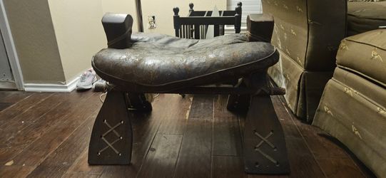 Authentic camel saddle, wood and leather wrapped cushion.
