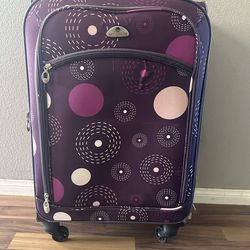 Beautiful purple luggage with lots of compartments has handle to Stowe over the seat on the airplane &also  has tall handle for pulling the luggage an