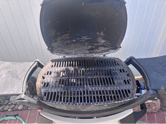 Used Weber electric grill with cover and stand.