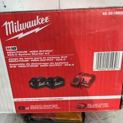 Milwaukee Charger And Two 6.0(m18)