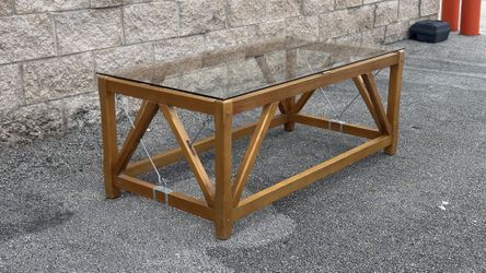 COFFEE CENTER TABLE W WOODEN LEGS & GLASS ON TOP - delivery is negotiable