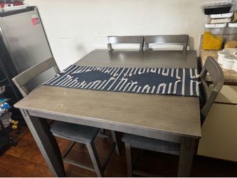 Table with 4 chairs for sale. Good condition overall. One chair has a small crack damage as shown in