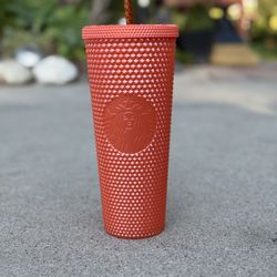Orange Studded Starbucks Cup.