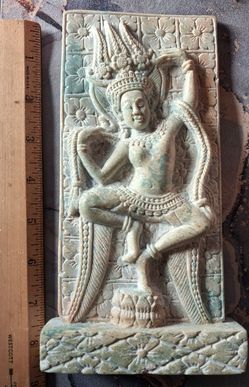 stone carving resembles a Khmer-style Apsara dancer,