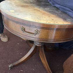 1940s-era round mahogany drum table with a leather top