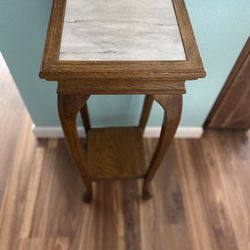 Oak pedestal table with marble top